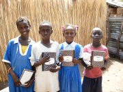 children holding exercise books