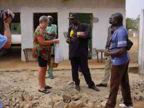 Vi & Jackie talk to school staff outside a classroom