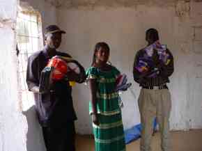 head teacher and two clss teachers holding some of the gifts