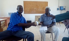 Wandifa handing over funding for the staff quarters