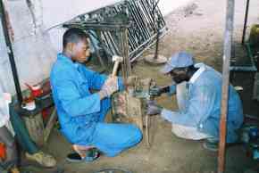 local workers making parts for the basketball posts