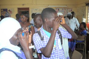 Children from the local school looking through really good cardboard binoculars