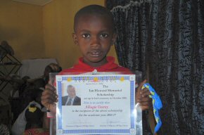 Alhagie with his scholarship certificate