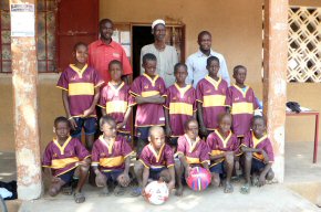 The football kit with the principal, vice principal and the village leader