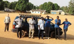 our Gambian team, school staff and Andy looking up at the solar panels