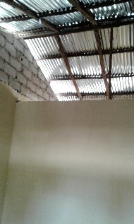 female staff quarters showing the lack of ceilings