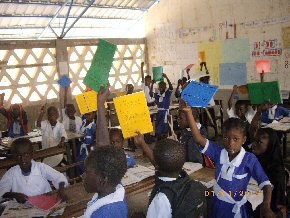 children at Kolior with exercise books