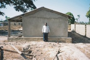 the committee chairman at the side of the cement rendered building