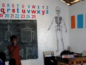 humorous skeleton behind the teacher's desk