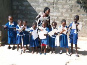 children with their new whiteboards working outside with Natoma