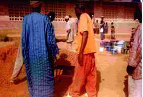 concrete being mixed outside of a classroom block