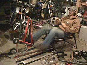 Tim Johnson from Engineers without Borders  tries out a prototype pedal powered grain mill