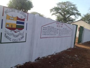 outside of the school wall, with school badge and welcome message