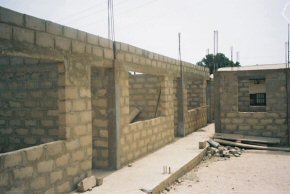 looking along the front - the small building at the right will be the school office