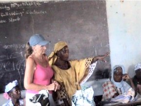 Pippa and Mariama explaining the loan scheme to the assembled ladies