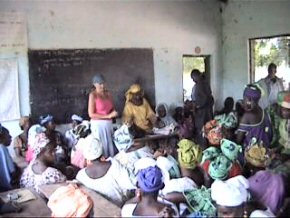 Pippa and Mariama explaining the loan scheme to the assembled ladies