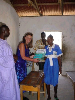 Pippa presents a girl pupil with a prize folder