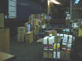 cardboard boxes and other packages waiting to be loaded into the container