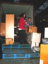 furniture and other pakages being loaded into the container