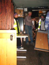 another shot of furniture and other pakages being loaded into the container