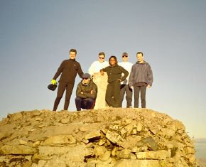 Chris and his party pose on the cairn at the top of Ben Nevis