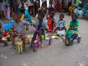 children trying out their tricycles