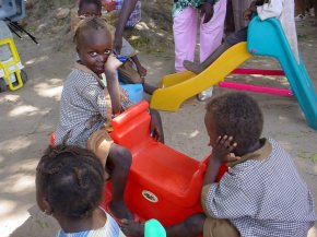 children on a sea saw and using a slide