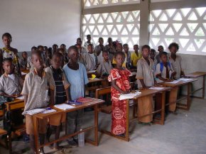 children stand at their desks in one of the new classrooms