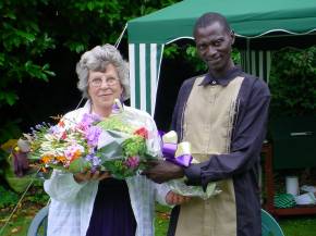 Bakary presents a bouquet to Diana