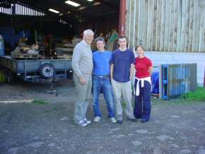 Ian Chris Craig and Amanda outside the barn while packing pallets