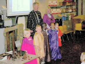 teachers and children of Gallions Mount School try on Gambian costumes