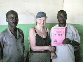 Pippa and staff of Crab Island with a copy of  'General Science' written by F. Sherrif, the teacher holding the book