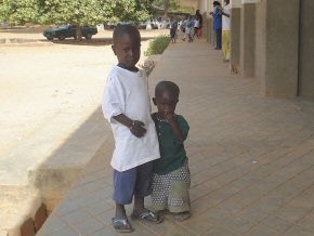 Two younger children belonging to one of the teachers who accompany her to school and amuse themselves while she teaches