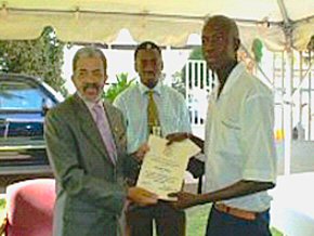 Alhassan Darboe receiving his prize from US Ambassador Mr Barry L Wells