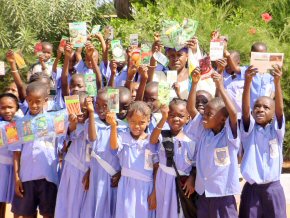 school children with packets of donated seeds