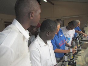 Student teachers at a Pageant workshop being shown how to use donated microscopes