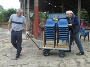 Ben and Ian taking chairs to the container