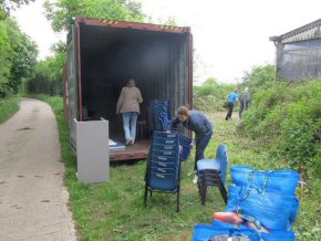 Frances stacking chairs beside the container