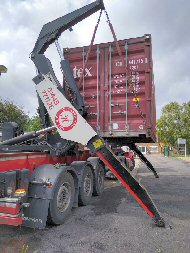 container lifted back onto trailer