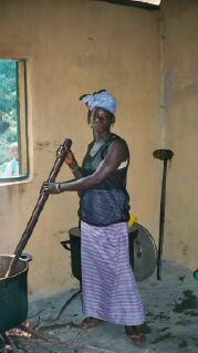 one of the cooks stirs a large pot inside the new kitchen