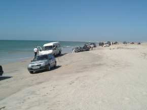 the convoy driving along the beach