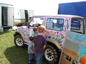 young sponsors add floral decorations to the jeep in its new pink colour scheme