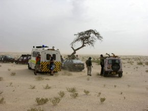 The ambulance, jeep and rest of the convoy in the desert