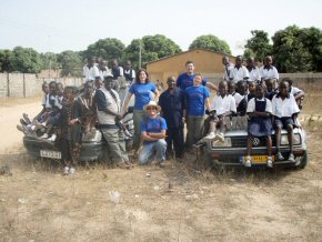 Both cars almost obscured by the children of Kings Kid