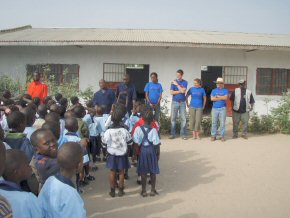 The teams and the children outside the Kings Kid school buildings