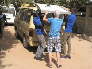 Brian helping to remove solar panels from the van