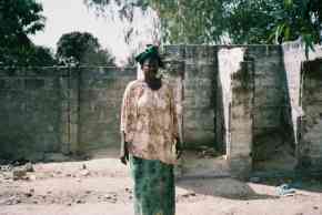 Saloum Nursery headmistress stands outside the defunct toilets