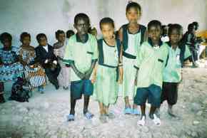 Saloum Nursery children in their classroom, showing the rubble floor