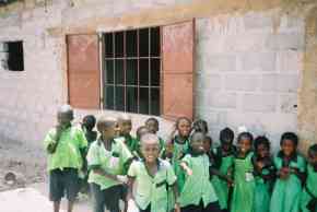 children outside the partly refurbished classroom at Saloum