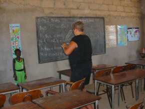 Jackie puts up some posters in the classroom